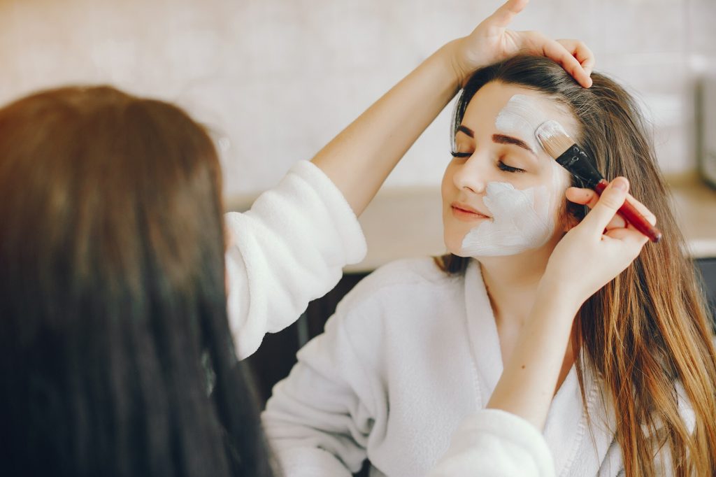 young girl with beautiful hands puts refreshing mask her girlfriend s face with brush 1157 14219