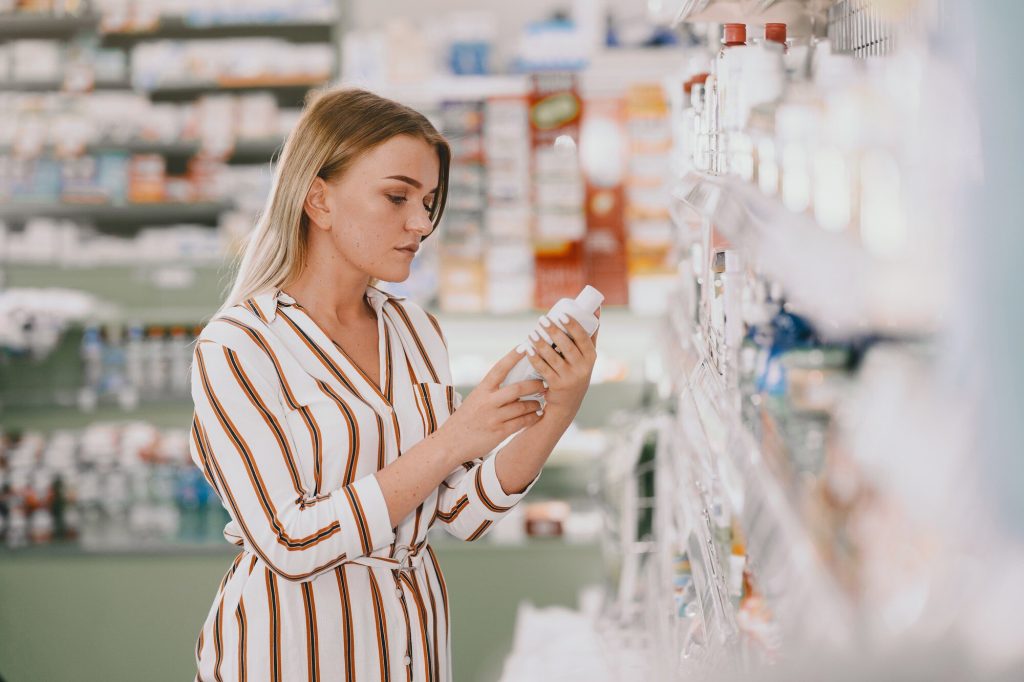 medicine pharmaceutics health care people concept female taking medications from shelf buyer 1157 42176