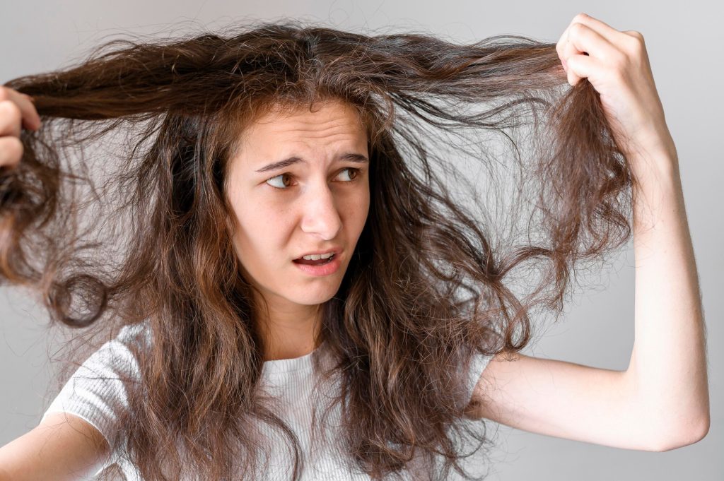 woman worried about tangled hair 23 2148547384